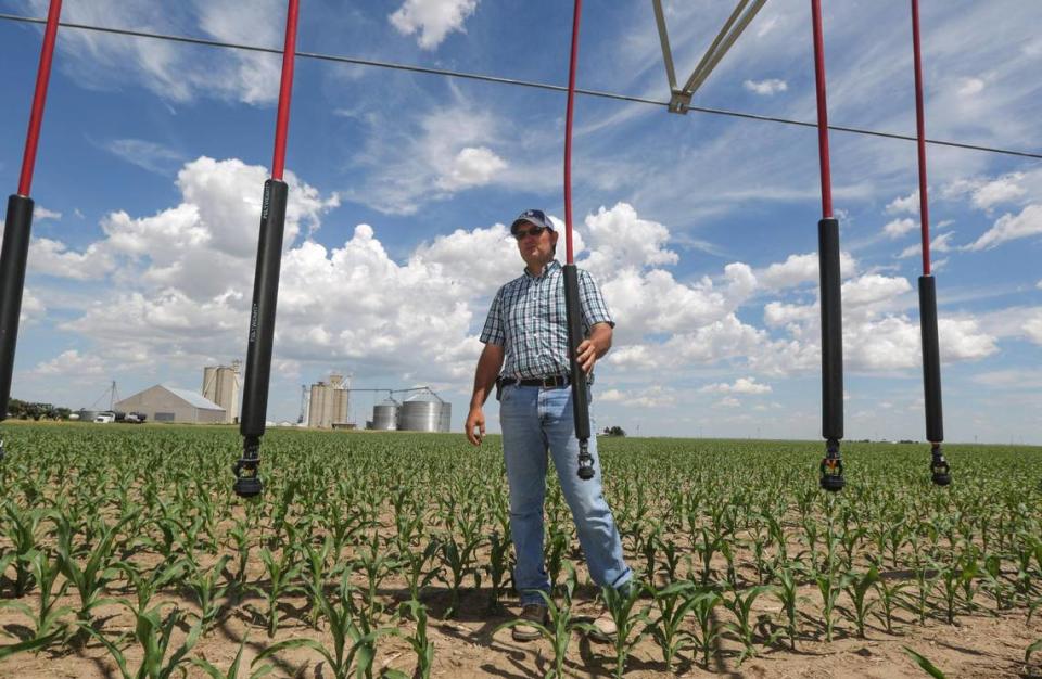 Clay Scott examines an irrigation pivot in a corn field near his family farm in Ulysses, Kansas in 2015.