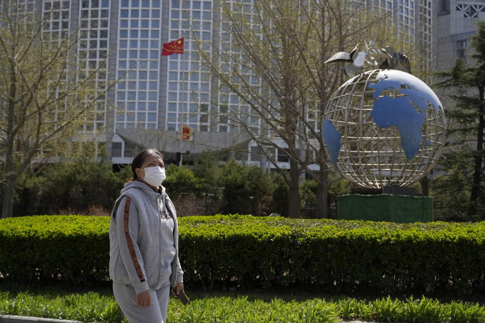 A woman walks past the Ministry of Foreign Affairs in Beijing, Sunday, March 26, 2023. Honduras formed diplomatic ties with China on Sunday after breaking off relations with Taiwan, which is now recognized by only 13 sovereign states, including Vatican City. (AP Photo/Ng Han Guan)