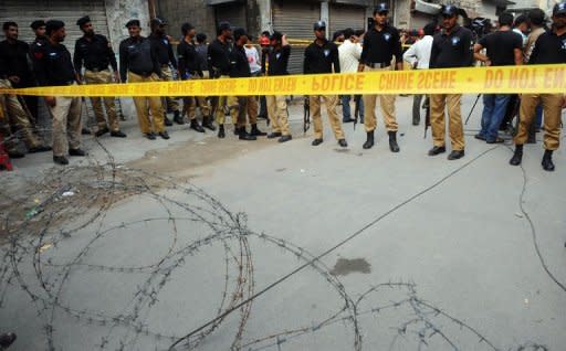 Pakistani policemen seal off a police hostel in Lahore after it was attacked by gunmen on July 12, 2012. The gunmen shot dead nine police prison staff as they slept, the second attack on security forces in the country's political heartland since Islamabad reopened a NATO supply corridor