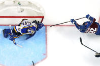 Colorado Avalanche left wing Gabriel Landeskog (92) scores a goal against St. Louis Blues goaltender Jordan Binnington (50) during the third period in Game 2 of an NHL hockey Stanley Cup second-round playoff series Thursday, May 19, 2022, in Denver. The Blues won 4-1. (AP Photo/Jack Dempsey)