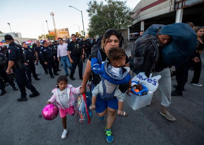 A migrant family carries their belongings after Ciudad Juarez municipal police begin to remove migrants on Monday, May 22, 2023, who had camped in front of a migrant facility where 40 migrants died as a result of a fire on March 27, 2023. 