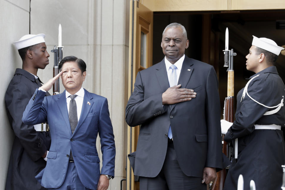 Secretary of Defense Lloyd Austin, right, and Philippines President Ferdinand Marcos Jr., left, stand during the American national anthem at an enhanced honor cordon ceremony at the Pentagon, Friday, April 12, 2024. (AP Photo/Luis M. Alvarez)