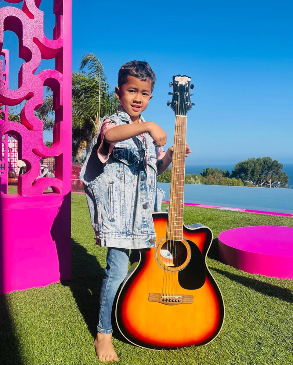 Miles, 7, is rocking his Ken look at Barbie's Malibu DreamHouse. (Chrissy Teigen / Instagram)