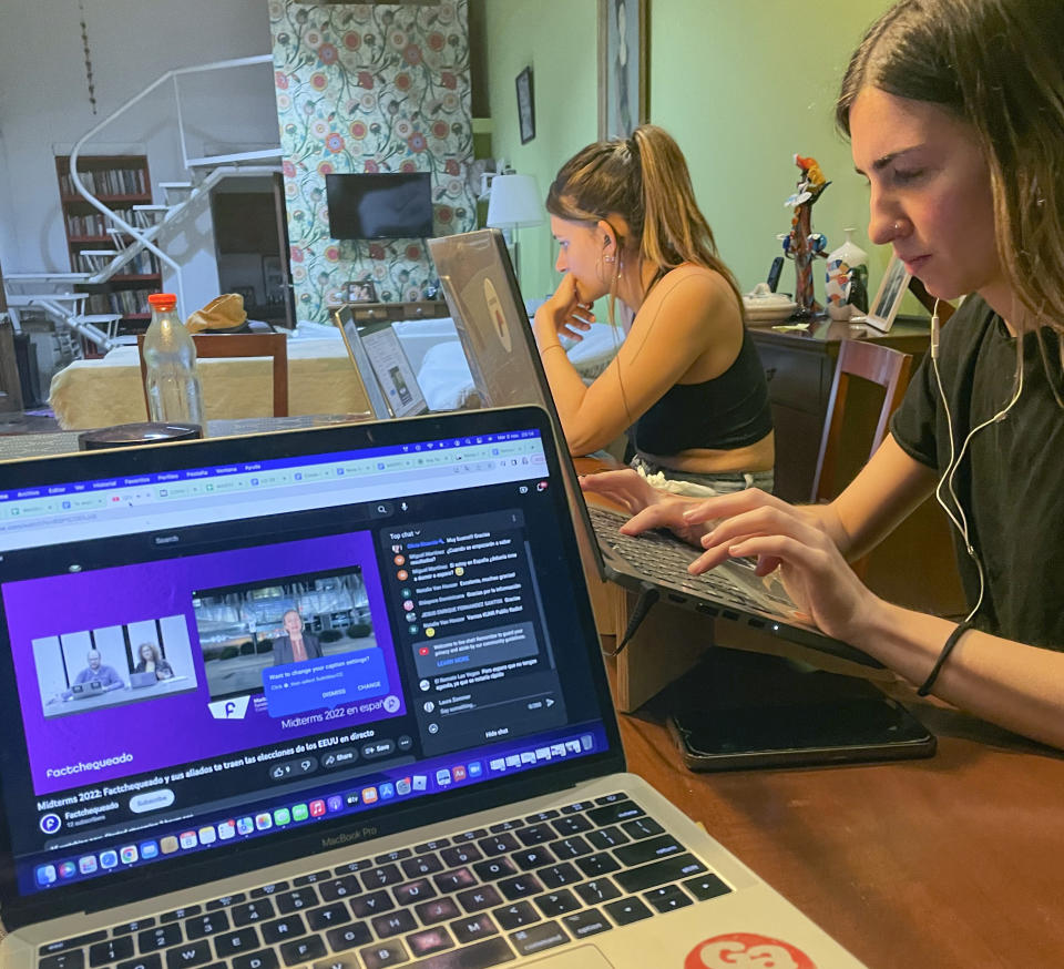 Olivia Rivarola, left, Factchequeado social media and communications manager, and Paula Martinetti, special projects analyst, work from Buenos Aires, Argentina, on the night of the 2022 U.S. Midterm elections, Nov. 8, 2022, with Factchequeado's cofounder Laura Zommer. The Spanish-language fact-checking group was founded to combat disinformation targeting Spanish-speaking communities. Community organizations are gearing up for what they expect will be a worsening onslaught of disinformation targeting voters of color as the 2024 election approaches. (Laura Zimmer/Factchequeado via AP)