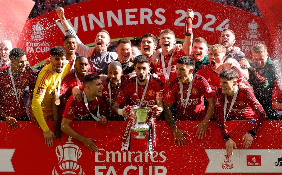 Manchester United's Bruno Fernandes celebrates with the trophy