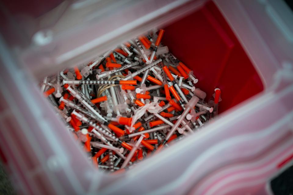 A Caracole harm reduction site collects and safely discards used syringes from people who use drugs.