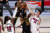 Los Angeles Lakers forward LeBron James scores between Miami Heat forward Jae Crowder, left, and guard Tyler Herro during the second half in Game 5 of basketball's NBA Finals Friday, Oct. 9, 2020, in Lake Buena Vista, Fla. (AP Photo/John Raoux)