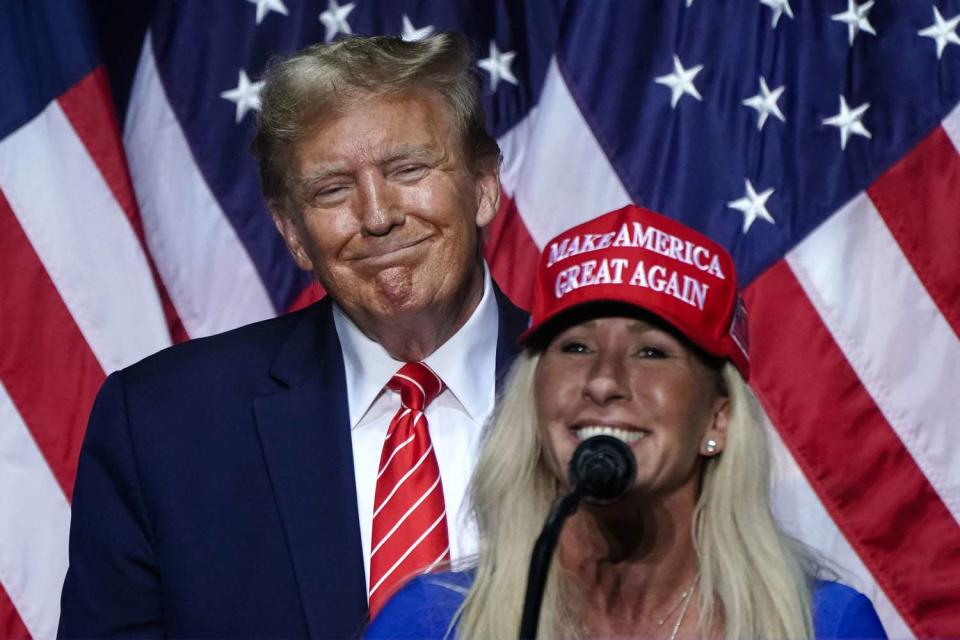 <p>ELIJAH NOUVELAGE/AFP via Getty</p> Georgia Rep. Marjorie Taylor Greene dons a MAGA hat on March 9, 2024, while appearing at a campaign event with President Donald Trump