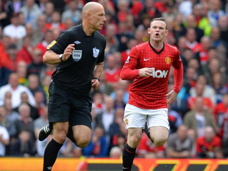 Wayne Rooney discusses the finer points of the game with Howard Webb (Getty)