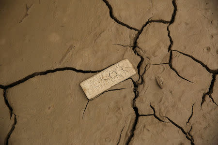 A remote control lies in mud after rivers breached their banks due to torrential rains, causing flooding and widespread destruction in Carapongo Huachipa, Lima, Peru, March 24, 2017. REUTERS/Mariana Bazo