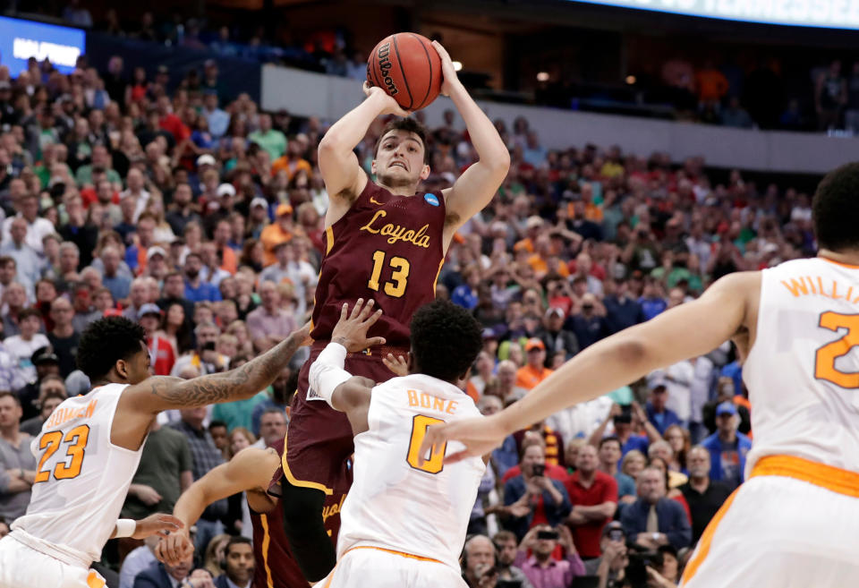 Loyola-Chicago guard Clayton Custer (13) shoots over Tennessee’s Jordan Bowden (23) and Jordan Bone (0) and scores in the final seconds of a 63-62 win in a second-round game at the NCAA men’s college basketball tournament in Dallas. (AP Photo/Tony Gutierrez)