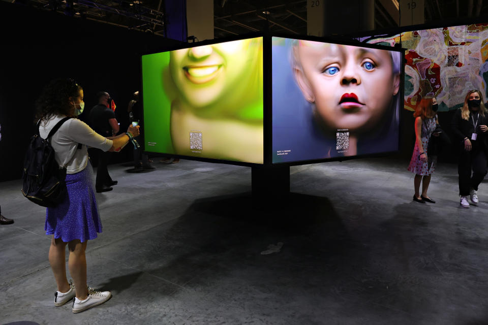 Guests view an NFT art piece by German artist Mario Klingemann at Art Basel Miami 2021.<span class="copyright">Photo by Cindy Ord/Getty Images</span>