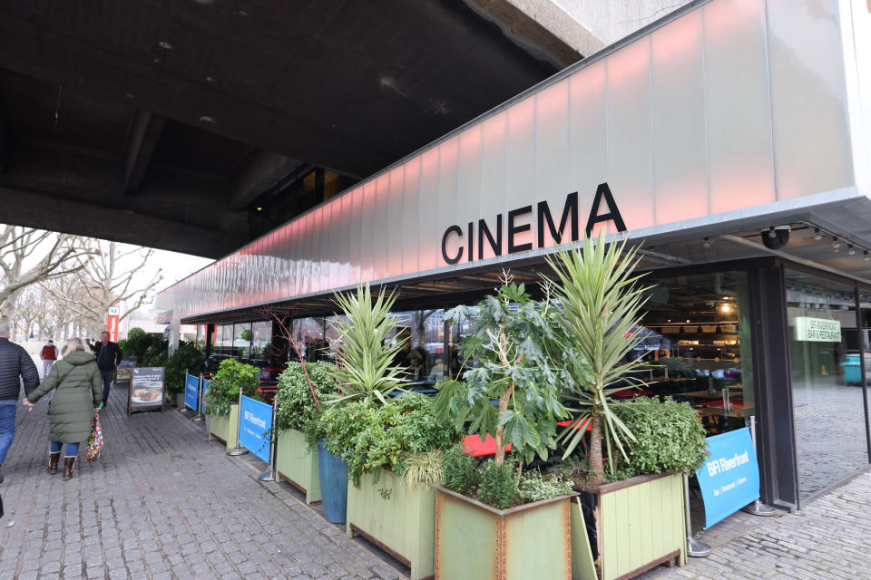 Sign for a cinema with some plants underneath