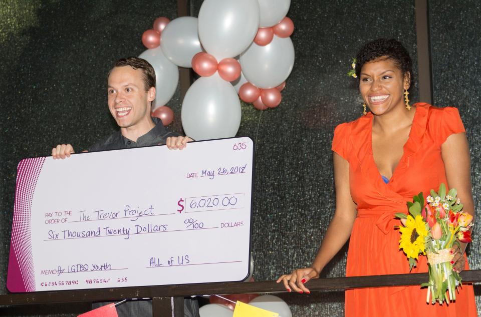 Mark Ritterhoff (left), a fraternity brother, and Ashley Burroughs, an undergraduate friend, announced the total fundraised for the Trevor Project for Diane's bridal registry. (Photo: <a href="http://www.elyssamaxxgoodman.com/" target="_blank">Elyssa Goodman</a>)