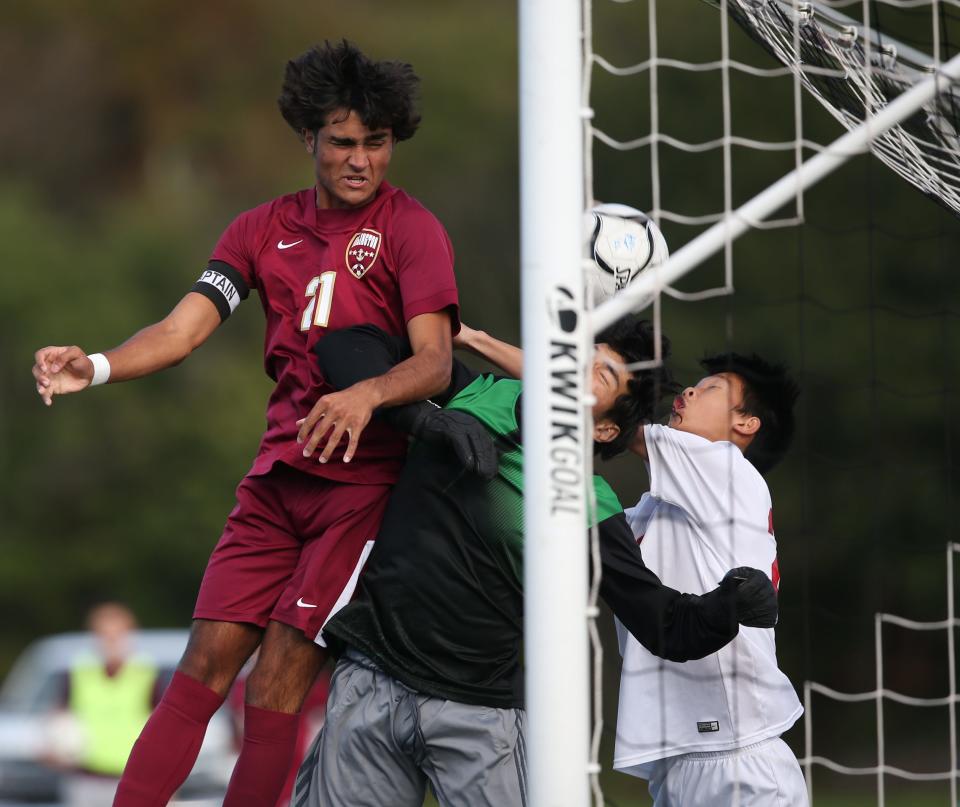 Arlington's Michael Cocca attempts a header on Robert Sherman's shot  as Roy C. Ketcham's goalie, Ervin Cruz Rubio attempts a save during Wednesday's boys soccer game in Freedom Plains on September 28, 2022. 