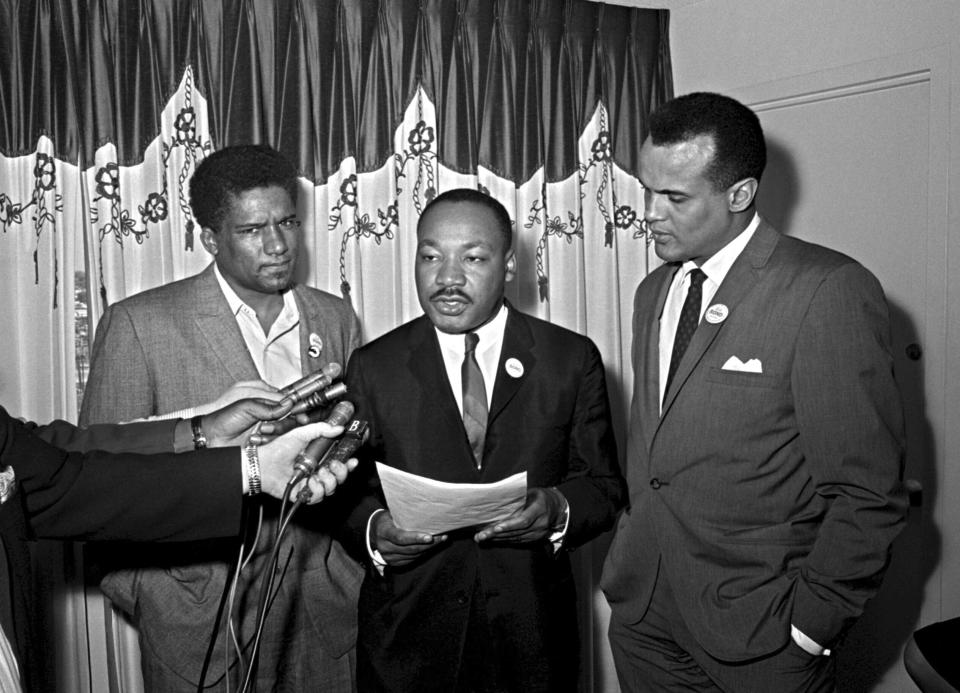 FILE - James Foreman, executive secretary of the Student Non-violent Coordinating Committee, left, Civil Rights leader Dr. Martin Luther King Jr., center, head of the Southern Christian Leadership Conference and activist-singer Harry Belafonte appear during a press conference in Atlanta on April 30, 1965. Belafonte died Tuesday of congestive heart failure at his New York home. He was 96. (AP Photo/Horace Cort, File)