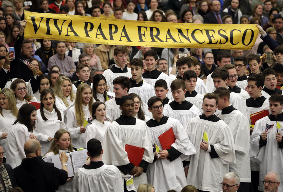 Members if the choir of St. Anthony High School from New York show a banner reading "up with Pope Francis" during the general audience in the Paul VI Hall at the Vatican, Wednesday, Feb. 20, 2019. (AP Photo/Alessandra Tarantino)