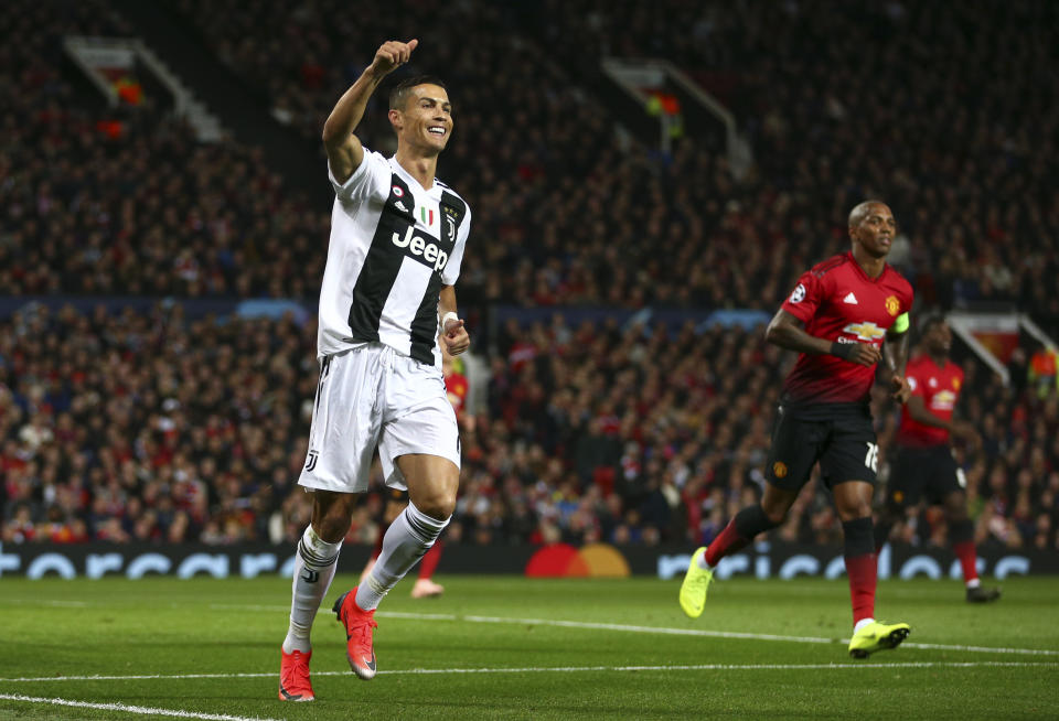 Juventus forward Cristiano Ronaldo gestures to a teammate during the Champions League group H soccer match between Manchester United and Juventus at Old Trafford, Manchester, England, Tuesday, Oct. 23, 2018. (AP Photo/Dave Thompson)