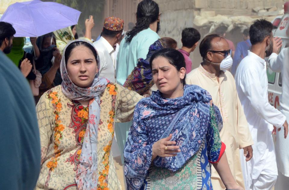 KARACHI, PAKISTAN, MAY 22: Pakistani people arrive at the site of a passenger plane crash in Karachi, Pakistan, May 22, 2020. A Pakistani passenger plane with at least 100 people on board crashed in a residential area in the Pakistani city of Karachi on Friday, the country's civil aviation agency said (Photo by H.KHAN/Anadolu Agency via Getty Images)