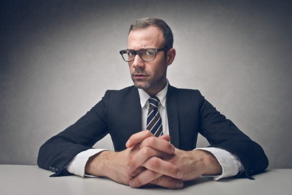 serious businessman sitting at...