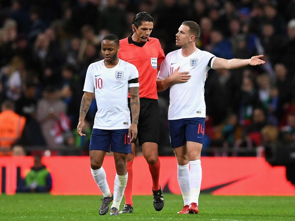 Jordan Henderson remonstrates with the referee after Italy's penalty: Getty