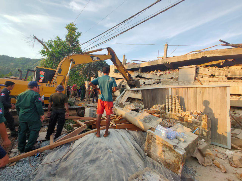 Photo provided by the Kep Province Authority Police, heavy machinery removes debris after a building collapsed in Kep province, Cambodia, Friday, Jan. 3, 2020. At least two construction workers were killed when a seven-floor building collapsed in the southern Cambodian town of Kep on Friday, according to the police. (Kep province Authority Police via AP)