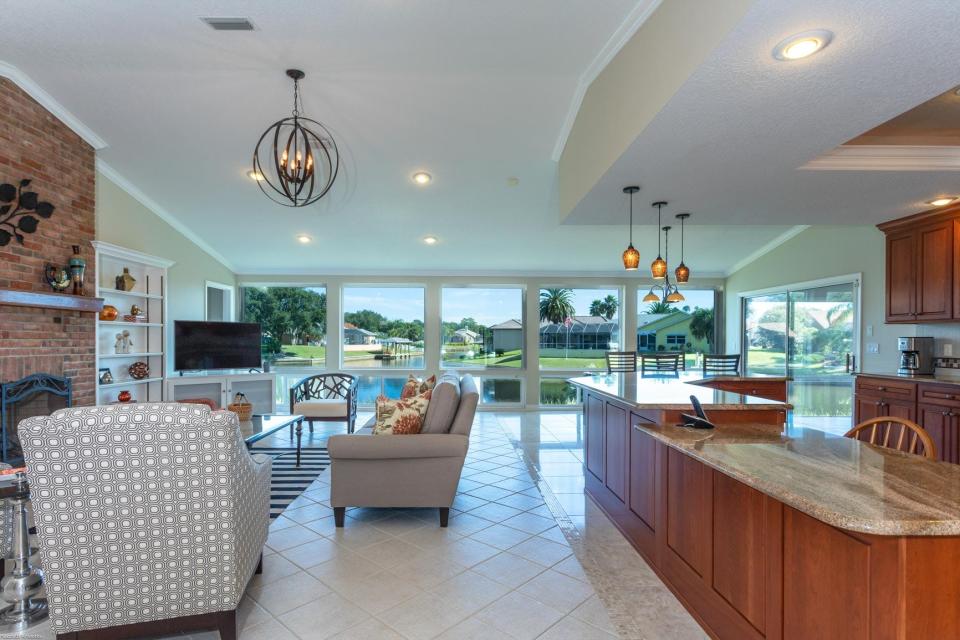 The family room has a solid-brick fireplace for a cozy look and five picture windows across the entire back area for exquisite views.