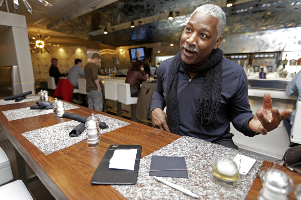 In this photo taken Tuesday, Dec. 18, 2012, at O'Hare International Airport in Chicago, blues musician Cedric "Catfish" Turner has a drink at ICE Bar in Terminal 3 between flights. Getting stranded at an airport once meant camping on the floor and enduring hours of boredom in a kind of travel purgatory with nothing to eat but fast food. Tough economic times are helping drive airports to make amends and transform terminals with a bit of bliss: spas, yoga studios, luxury shopping and restaurant menus crafted by celebrity chefs. (AP Photo/M. Spencer Green)