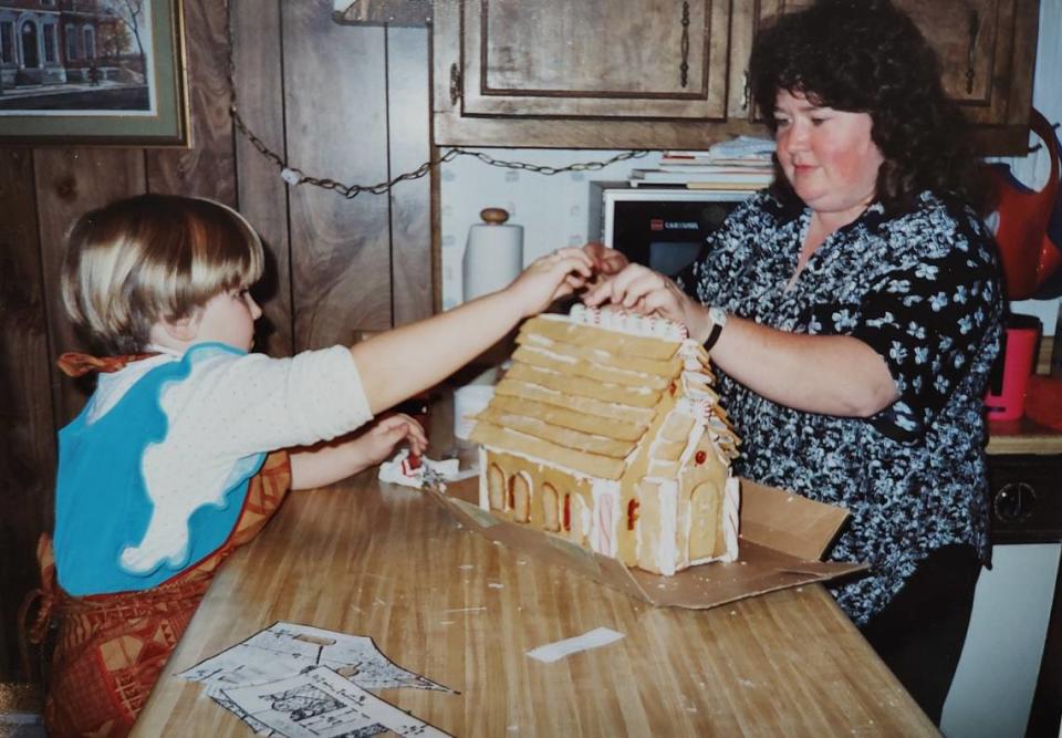 Fuquay-Varina’s Faith An (left) and Deborah Kinton work on a store-bought gingerbread house together “about 30 years ago,” An said.