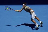 David Ferrer of Spain serves to Jeremy Chardy of France during their men's singles match at the Australian Open 2014 tennis tournament in Melbourne January 17, 2014. REUTERS/Jason Reed