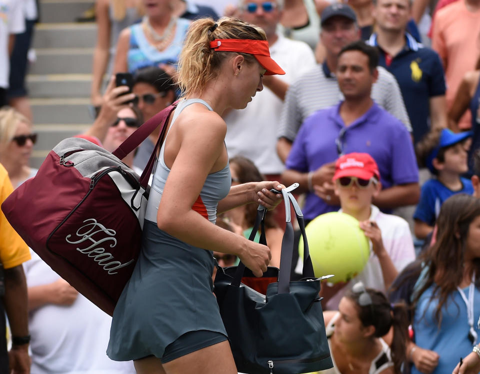 Maria Sharapova signs some autographs on the way out, after losing to Caroline Wozniacki at the U.S. Open Sunday. (Robert Deutsch-USA TODAY Sports)