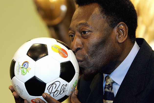 Brazilian football legend Pele kisses a - Credit: AFP via Getty Images