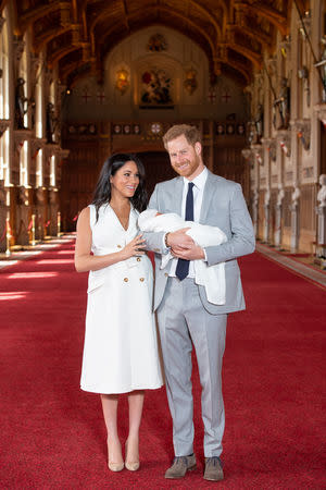 Britain's Prince Harry and Meghan, Duchess of Sussex are seen with their baby son, who was born on Monday morning, during a photocall in St George's Hall at Windsor Castle, in Berkshire, Britain May 8, 2019. Dominic Lipinski/Pool via REUTERS