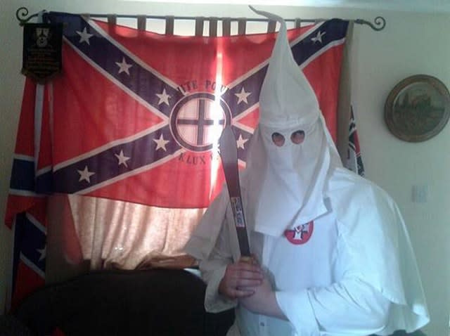 Adam Thomas wearing the hooded white robes of the Ku Klux Klan