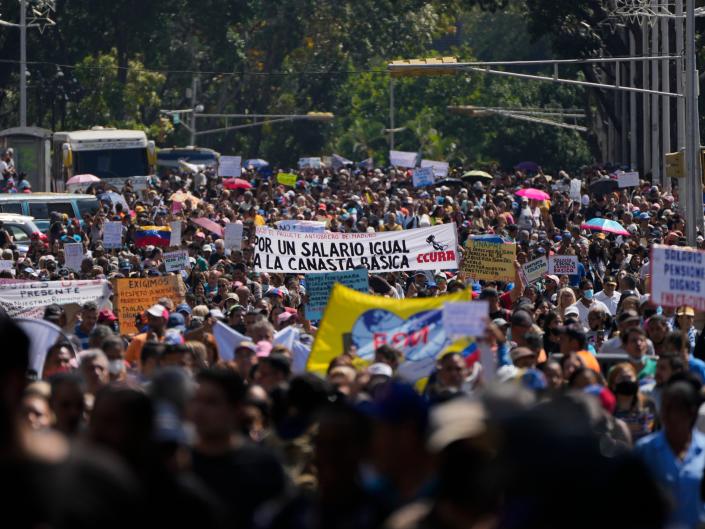 Teachers, other public workers and pensioners march for higher salaries and pensions, and payment of their full benefits on January 16, 2023, in Caracas, Venezuela, where the monthly minimum wage is about $7 dollars.