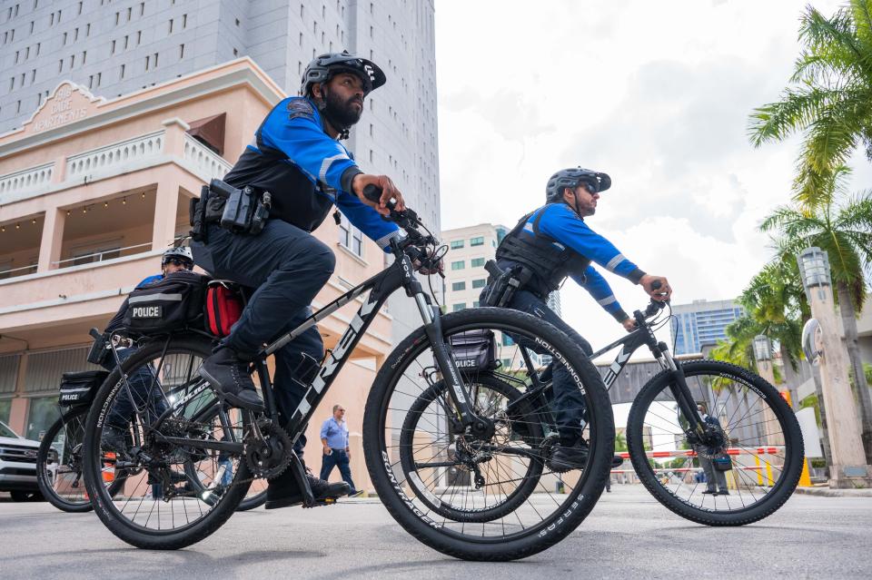 Miami police officers cycle south on North Miami Avenue outside the Wilkie D. Ferguson Jr. U.S. Courthouse on Tuesday in Miami. Former President Donald Trump was arraigned Tuesday afternoon, facing charges that he illegally retained national security documents after leaving office.