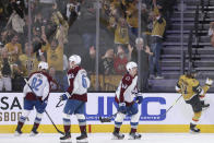 Colorado Avalanche defenseman Caleb Jones (82), left wing Artturi Lehkonen (62) and defenseman Josh Manson (42) look on as Vegas Golden Knights center William Karlsson (71) celebrates after his goal during the third period of an NHL hockey game Sunday, April 14, 2024, in Las Vegas. (AP Photo/Ian Maule)