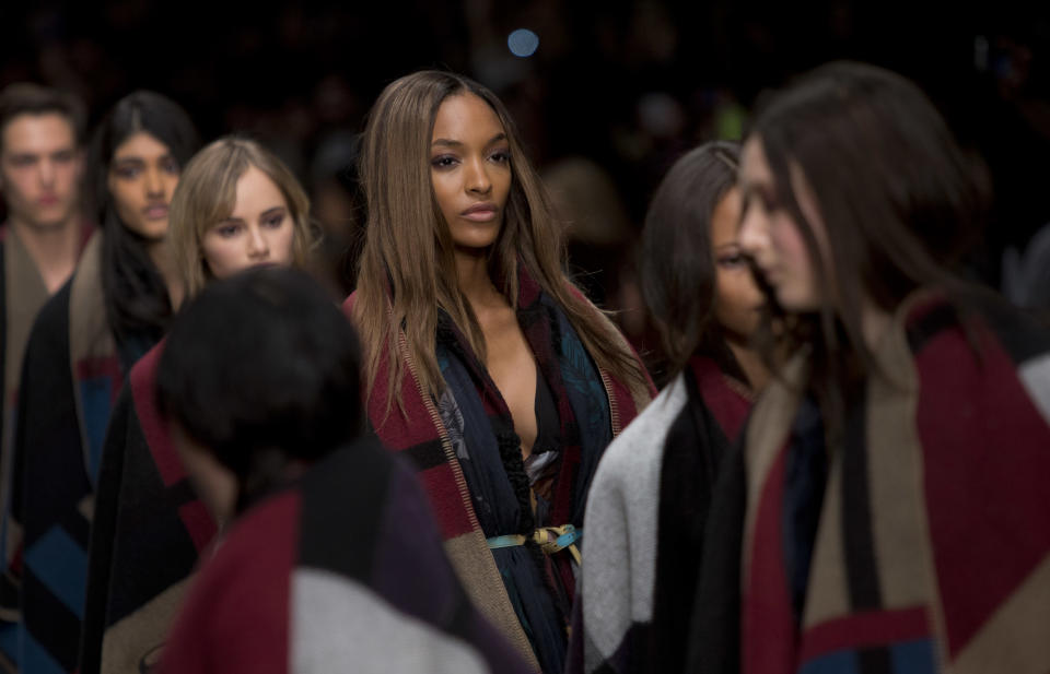 Model Jourdan Dunn, centre, wears a design created by Burberry Prorsum Womenswear during London Fashion Week Autumn/Winter 2014, at Perks Field, Kensington Palace, in Hyde Park, central London, Monday, Feb. 17, 2014. (Photo by Joel Ryan/Invision/AP)