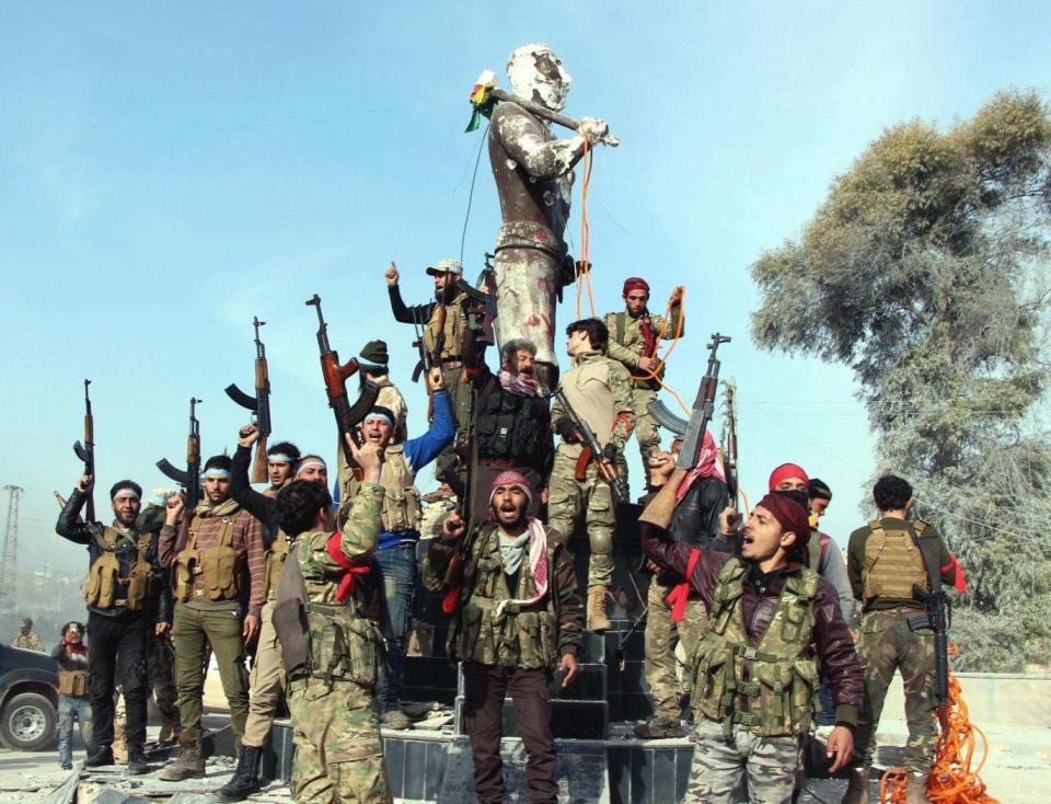 Soldiers prepare to destroy a statue of Kawa, a mythological figure in Kurdish culture (Hasan Kormozitao/DHA-Depo Photos via AP)