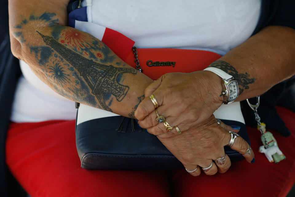 <p>An unidentified spectator wearing a tattoo depicting fireworks at the Eiffel tower that close Bastille Day, watches the military parade on the Champs Elysees in Paris, France, Friday, July 14, 2017. (Photo: Matthieu Alexandre/AP) </p>