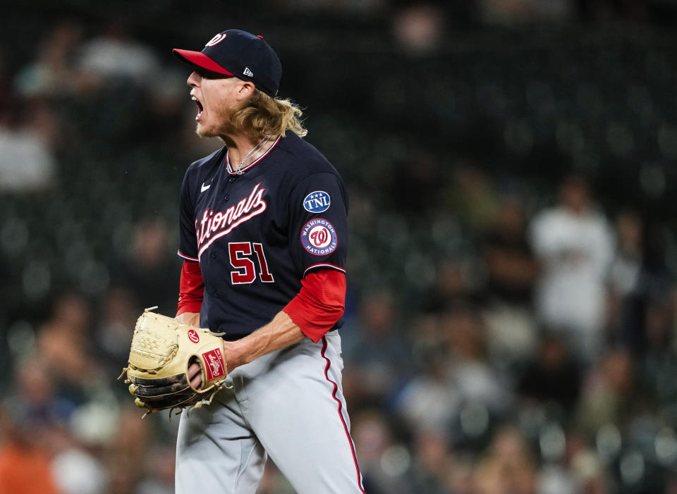 Washington Nationals relief pitcher Jordan Weems reacts to striking out Seattle Mariners' Dylan Moore during the 11th inning of a baseball game to seal a 7-4 win, Tuesday, June 27, 2023, in Seattle. (AP Photo/Lindsey Wasson)
