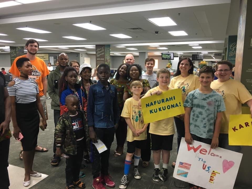 Powell Presbyterian Church's mission team greets a refugee family from Haiti at the airport.