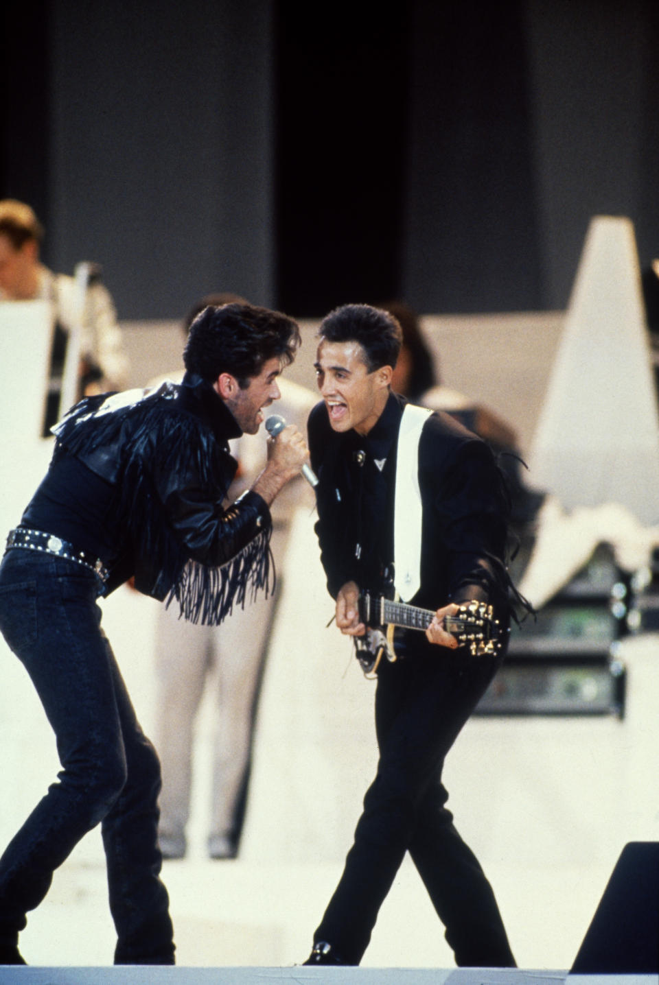 George Michael (left) and Andrew Ridgeley of pop duo WHAM! performing their farewell concert at Wembley Stadium, London, 28th June 1986. (Photo by Michael Putland/Getty Images) 