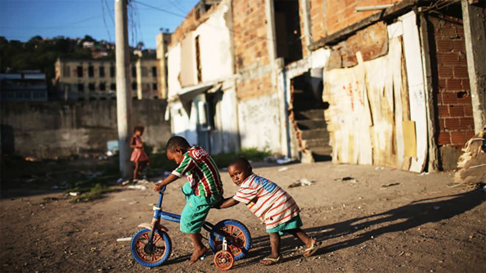 Kids play amidst the rubble of destroyed homes in the Metro-Mangueira community, or 'favela', located approximately 750 meters from Maracana stadium. Photo: Getty