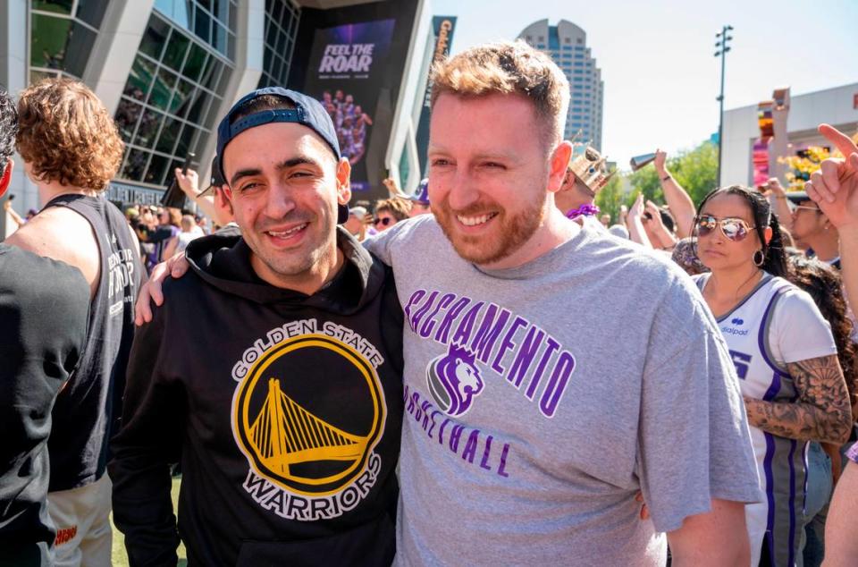 Paul Payam of San Francisco, a Warriors fan, stands with his friend Brian Farmer, a Kings fan, outside Golden 1 Center before the first playoff game Saturday, April 15, 2023. It was Farmer’s 30th birthday.