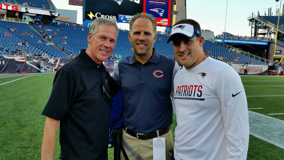 Former McKinley High School football coach Thom McDaniels (left) poses for a 2016 photo with two of his sons, Ben (center) and Josh, before a Bears-Patriots game the younger two McDaniels coached in.