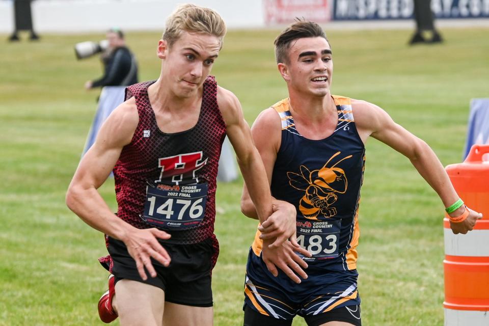 Ithaca's Parks Allen, right, and Hart's Clayton Ackley sprint to the finished line during the boys Division 3 state cross country final on Saturday, Nov. 5, 2022, at Michigan International Speedway in Brooklyn.