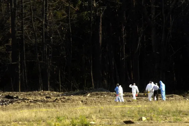 Investigadores dirigiéndose hacia el campo de escombros en el lugar donde se produjo el accidente del avión comercial cerca de Shanksville, Pensilvania, el 11 de septiembre de 2001. El accidente correspondió a uno de los cuatro aviones que fueron secuestrados como parte de un complot terrorista mortal y destructivo. En el peor ataque en suelo estadounidense desde Pearl Harbor, tres aviones secuestrados se estrellaron ese martes contra el Pentágono y el emblemático World Trade Center de Nueva York, demoliendo las dos torres de 110 pisos que simbolizaban el poder financiero de Estados Unidos.