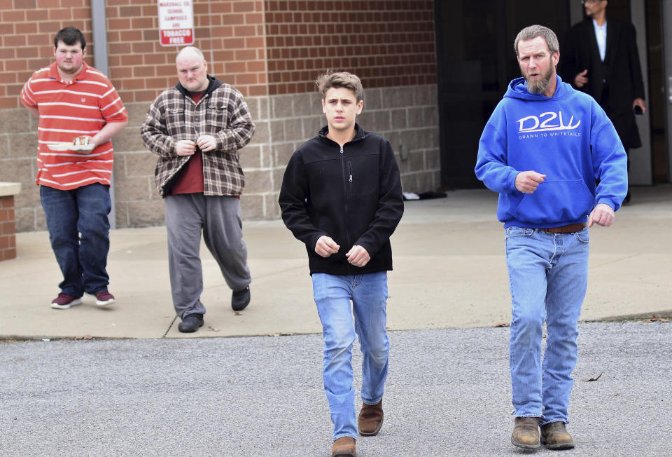 <p>Family members escort their children out of Marshal North Middle School near Palma, Ky., Tuesday, Jan. 23, 2018, after being transported from the Marshal High School. (Photo: Stephen Lance Dennee/AP) </p>