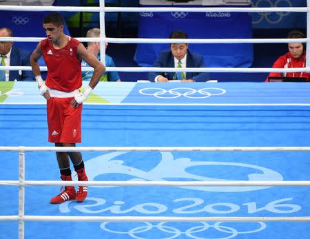 Aug 15, 2016; Rio de Janeiro, Brazil; Muhammad Ali (GBR, red) reacts after being defeated by Yoel Segundo Finol (VEN, blue) in a men's fly preliminary bout at Riocentro - Pavilion 6 during the Rio 2016 Summer Olympic Games. Mandatory Credit: John David Mercer-USA TODAY Sports